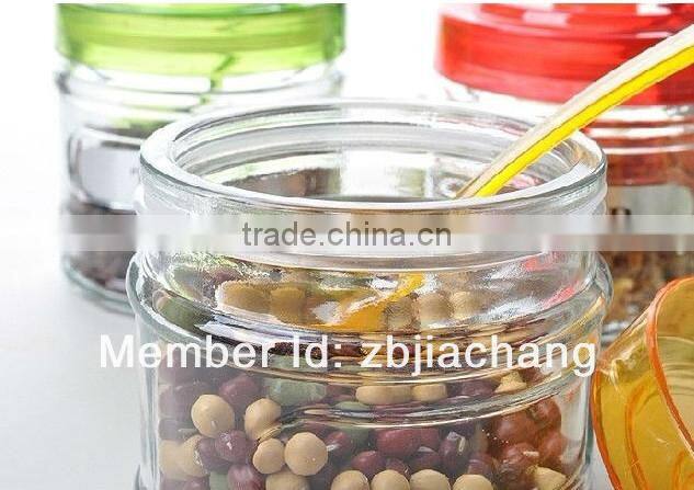 glass spice box with plastic cap and spoon