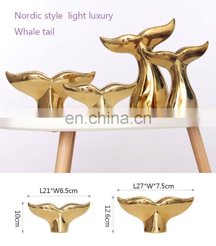 ceramic artwork of golden whale tail ornaments