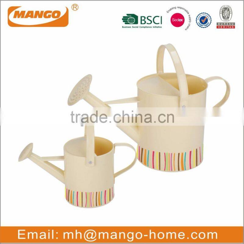colored garden metal watering can for plant with hand