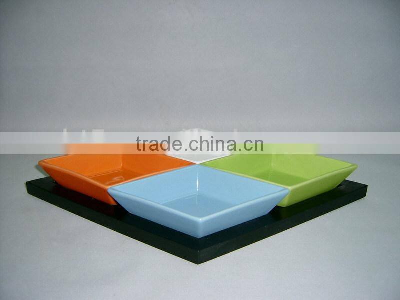 Colorful ceramic snack plates with wooden tray