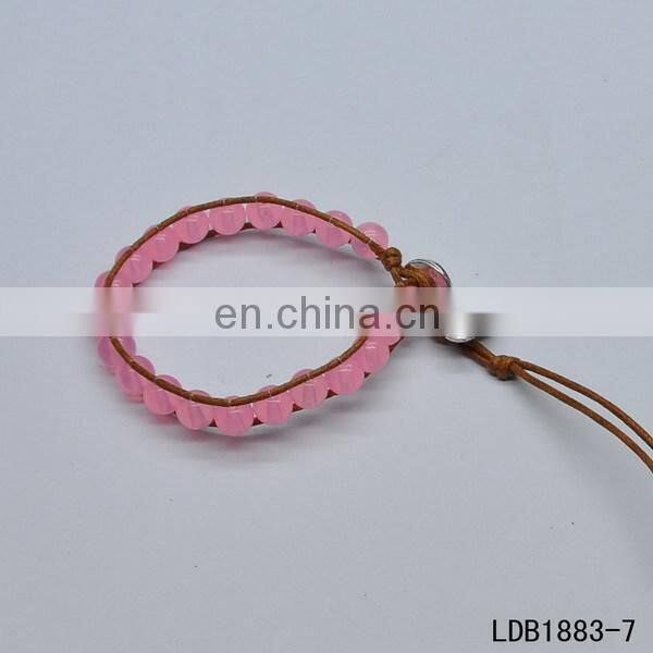 Handmade beaded wrap bracelet features 3 rows of circular and square stones surrounded by a natural colored cord on both sides