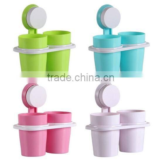 Adhesive toothbrush holder with suckers and two cups