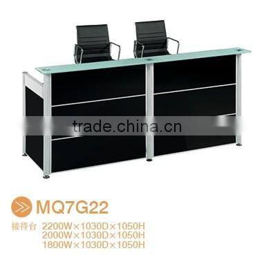 Black tufted reception desk made with tempered glass