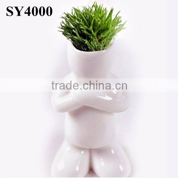 Energy little white man growing grass doll