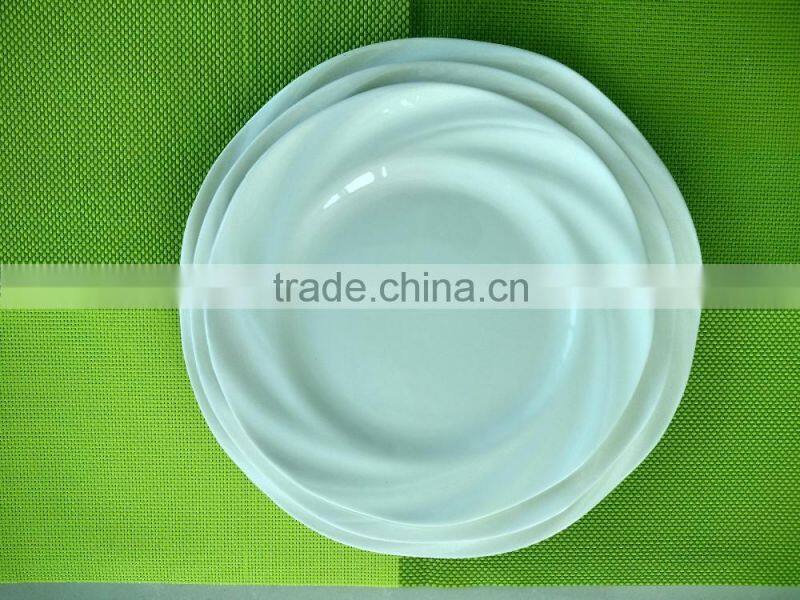 small white porcelain plates with cut edge shape