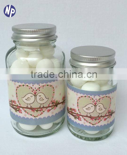 clear glass candy bottle with metal cover