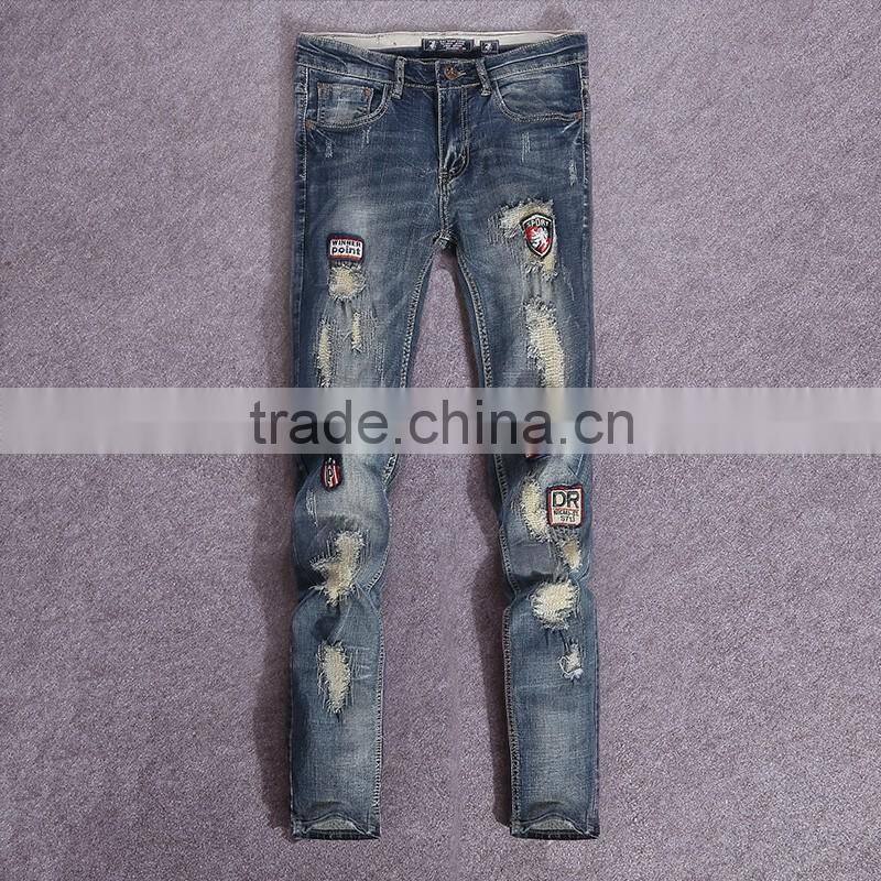 China jeans manufacture men ripped pattern plain badges jeans male vogue trouser