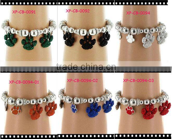 comfortable silvertone beaded stretch bracelet with crystal and enamel paw print charms