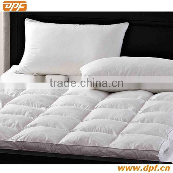 Hotel mattress pad with hollow fiber filling