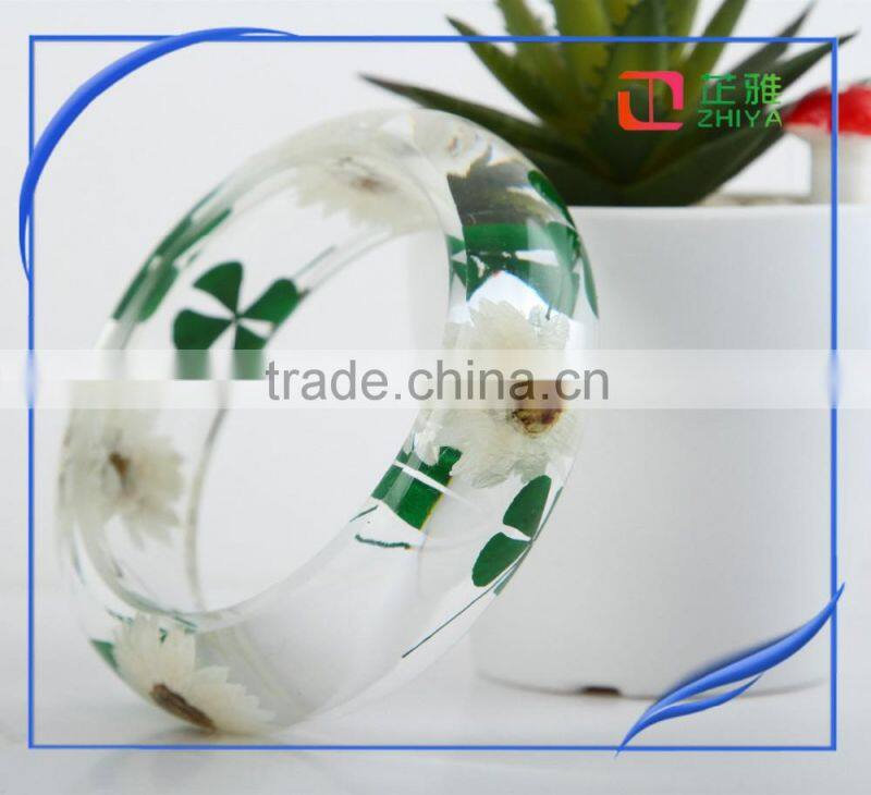 Pine needles inside transparent clear acrylic bangle stand