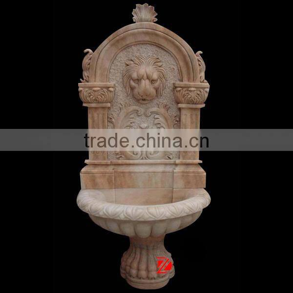 light yellow stone lion head wall fountain