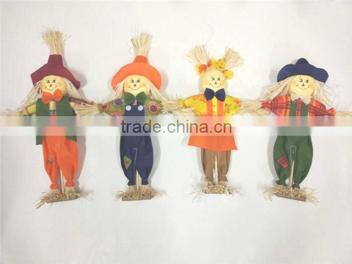 Paper straw and fabric scarecrow for autumn and harvest decoration