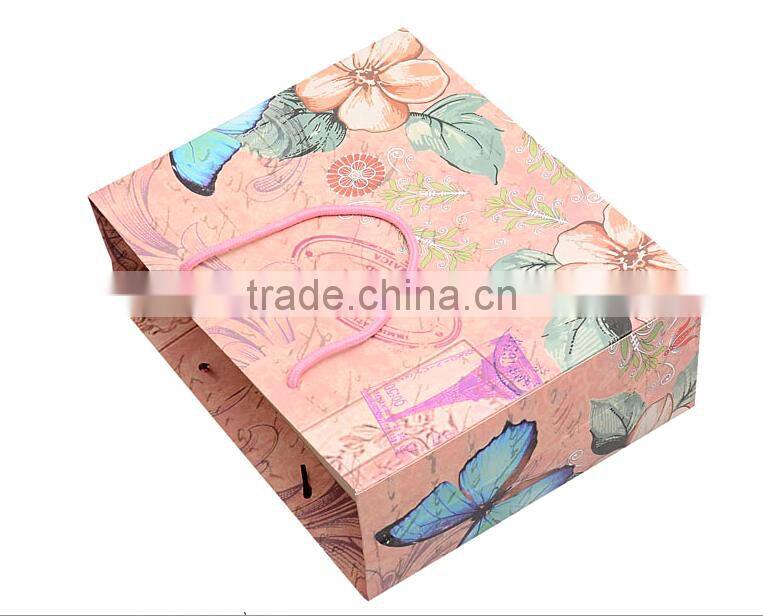 China brighten glossy limination paper bags for shopping with nylon handle