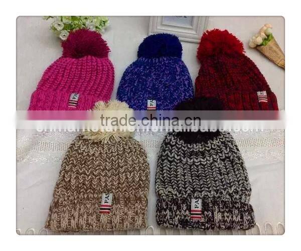 100% Acrylic kids size knitted hat with fashion sticker and top ball
