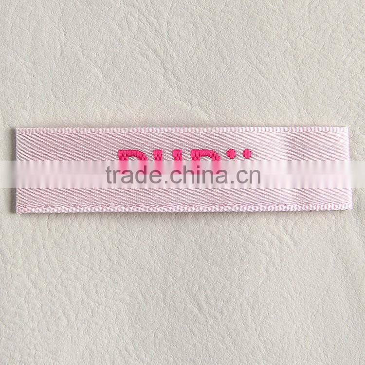 Garment woven label main label with white background and pink fonts