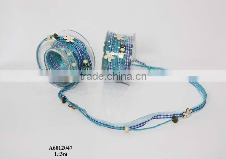 brown fabric ribbon with red balls