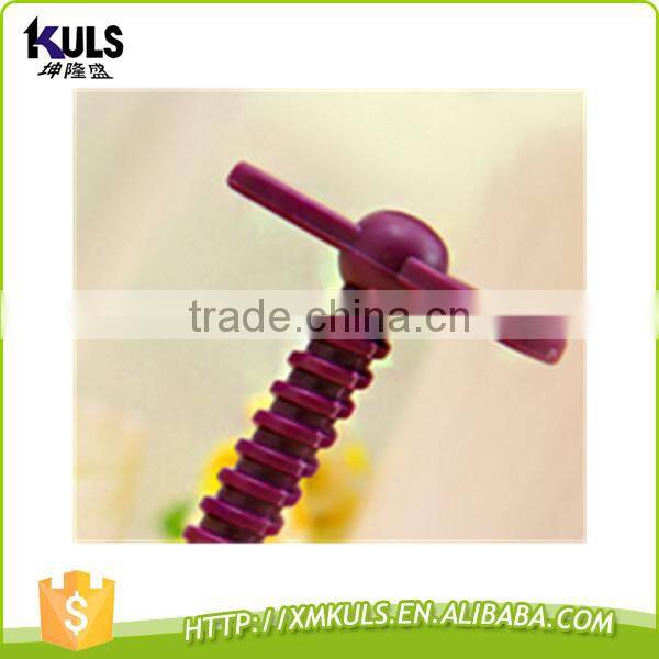 Small plastic tool for mashing garlic