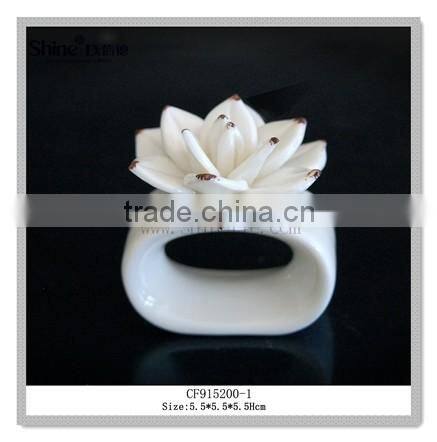 white ceramic napkin ring with flower shpae napkin holder