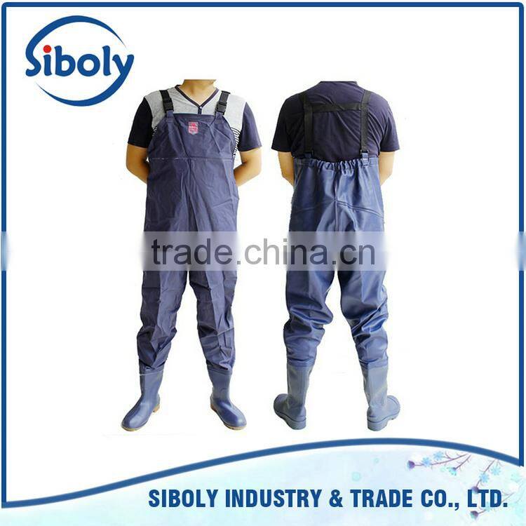 cheap pvc chest high fishing waders being used as waterproof workwear