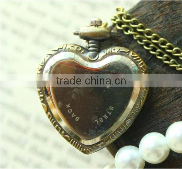 Cutting transparent glass heart shaped old pocket watch
