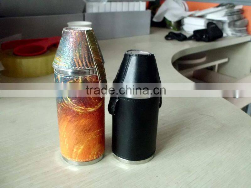 Cylindrical shape and suture and leather wrapped bottle and 2 glasses