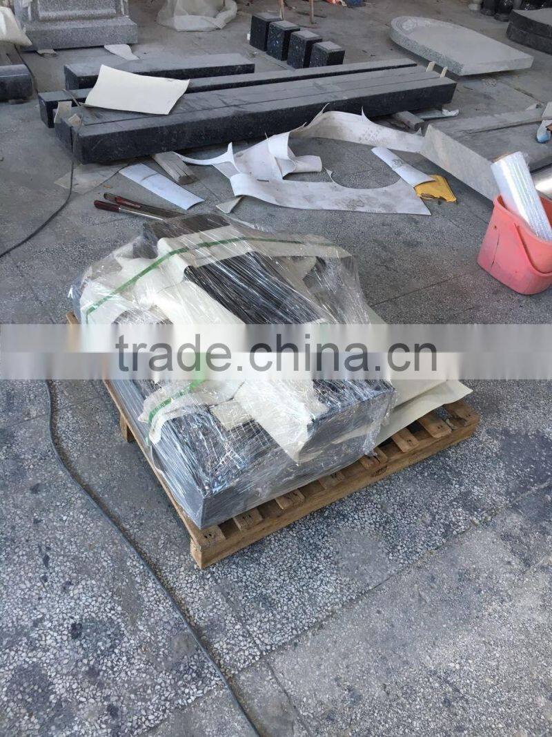 Hand carved angel holding granite heart tombstone