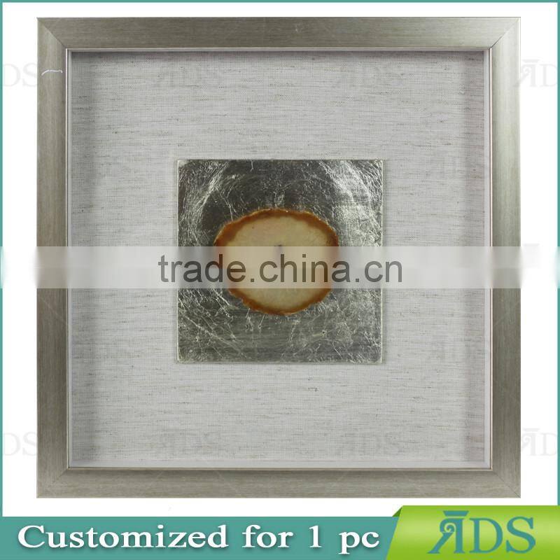 Box photo frames with mottled silver background encasing natural agate under glass