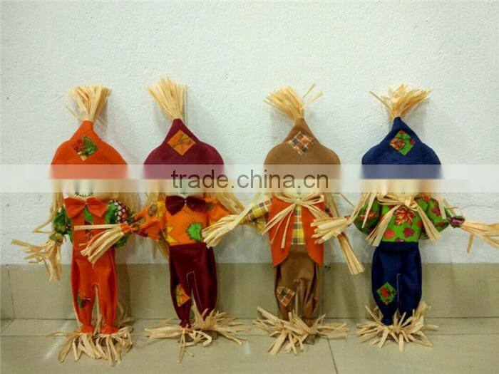 Paper straw and fabric scarecrow for autumn and harvest decoration