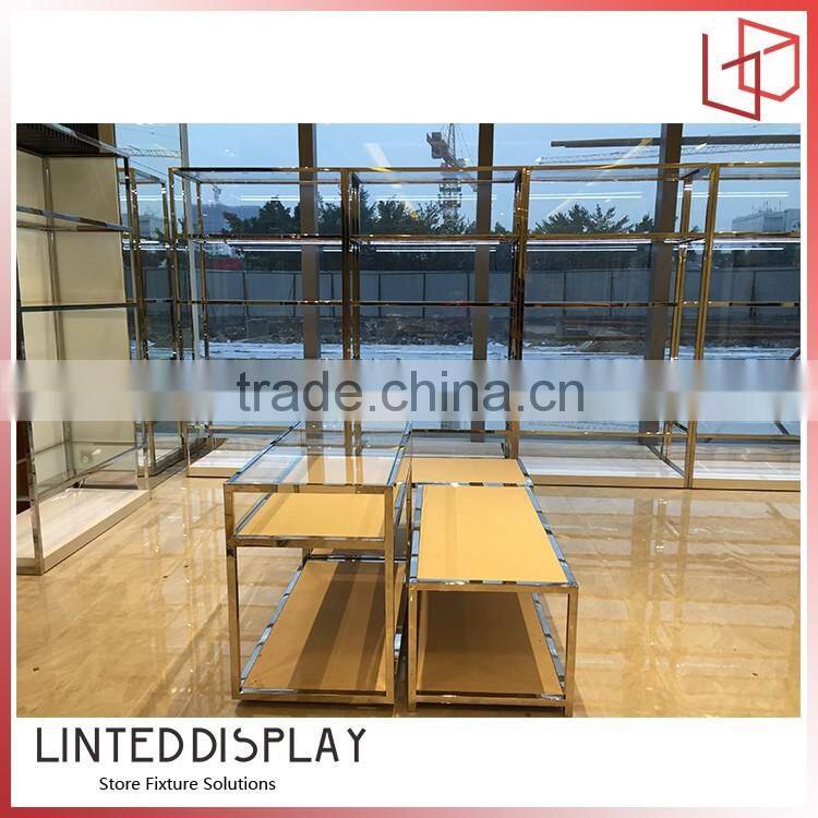 Unusual display stand for wall mounted retail clothing racks