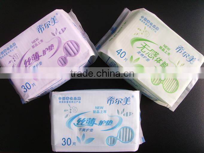 Disposable high absorbency dry surface sanitary napkin