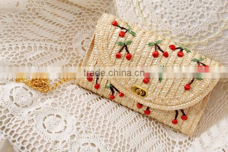 straw clutch bag with cherry pattern, gold chain cross body