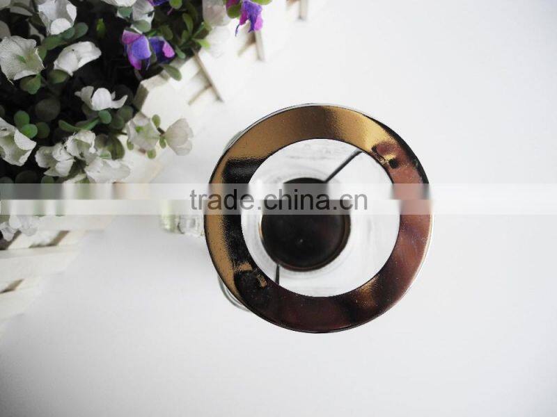 Decorated candle in clear glass jar