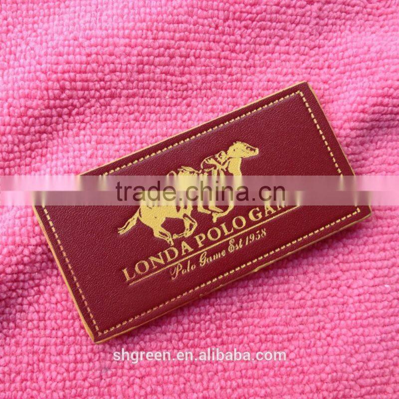 Soft debossed company name leather tags for suits
