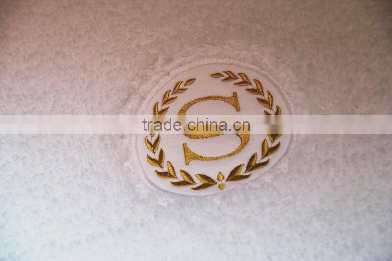 cotton bath rug hand tuffted with embroidered logo