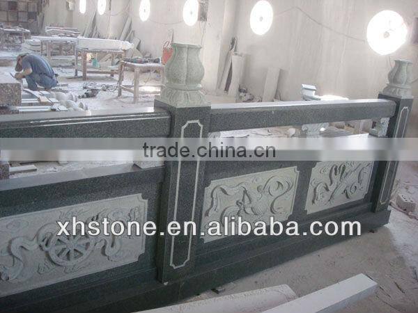 outdoor black stone handrail with carving statues