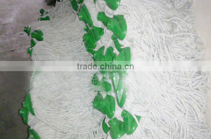 white cotton mop head with green plastic socket