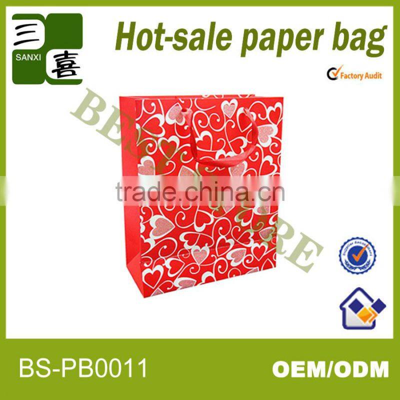 red printed paper gift carry bag with ribbon