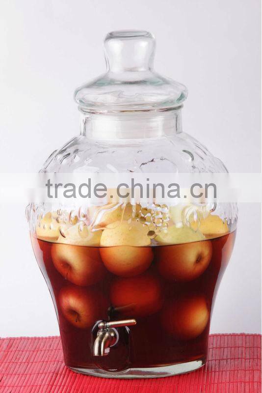 transparent round glass juice dispenser