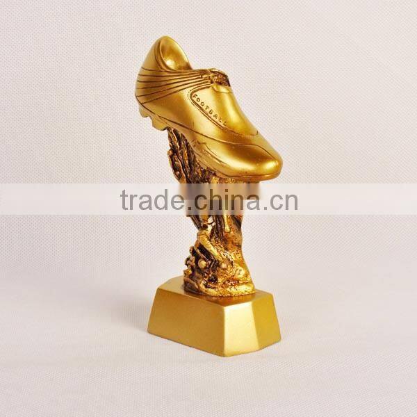 Gold football shoe with figure trophy