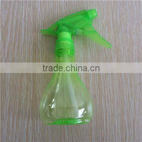 green transparent plastic garden spray bottle with trigger