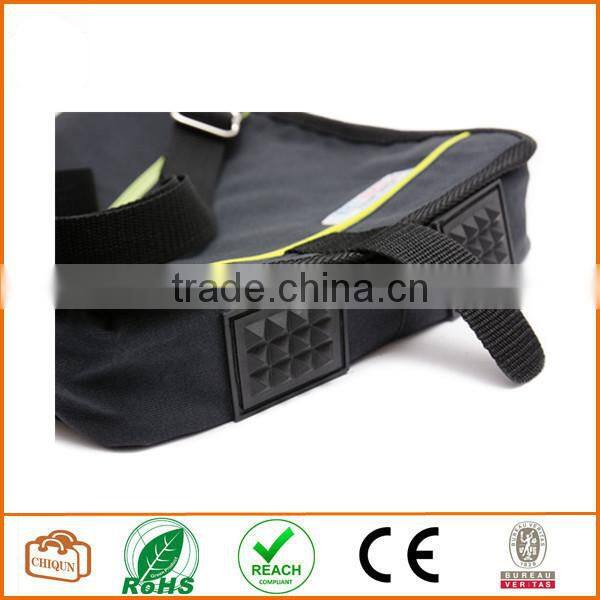 Unisex messenger bag and backpack. Dark Grey cotton canvas with green details and lining. Multiple pockets