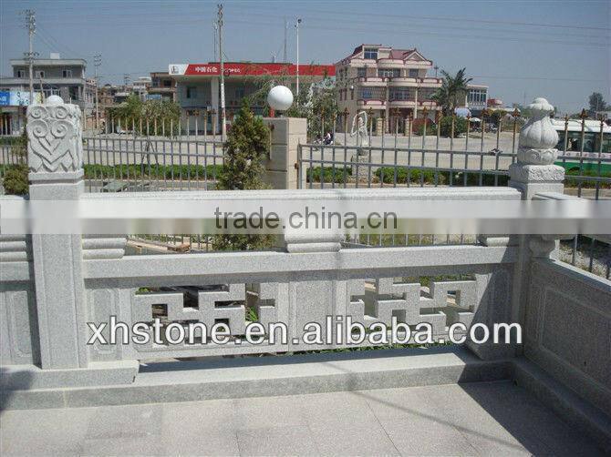 outdoor black stone handrail with carving statues