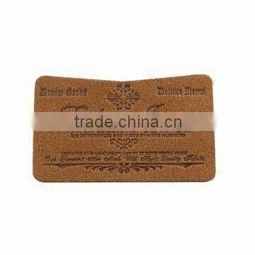 Custom & design embossed leather label for garment in dongguan