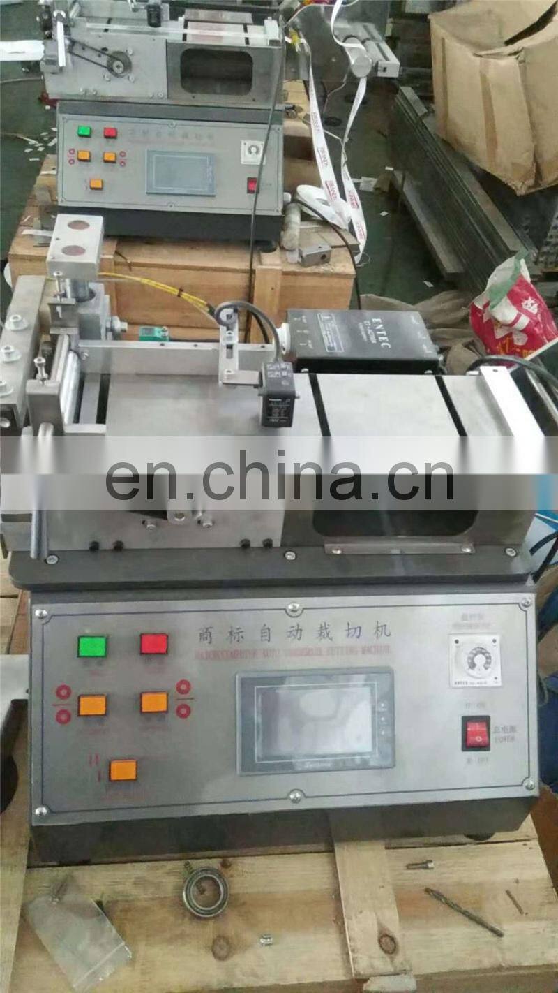 UGS2050 hot cold mini table top automatic fabric woven label cutting machine, small garment wash care ribbon cutter