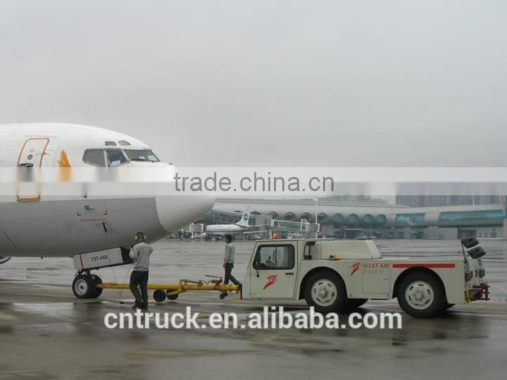 airplane aircraft dragging towing tractor
