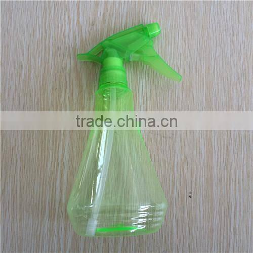 green transparent plastic garden spray bottle with trigger
