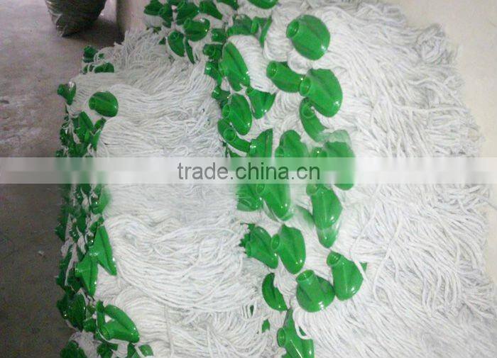 white cotton mop head with green plastic socket