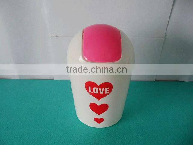 Round swing-top plastic trash can