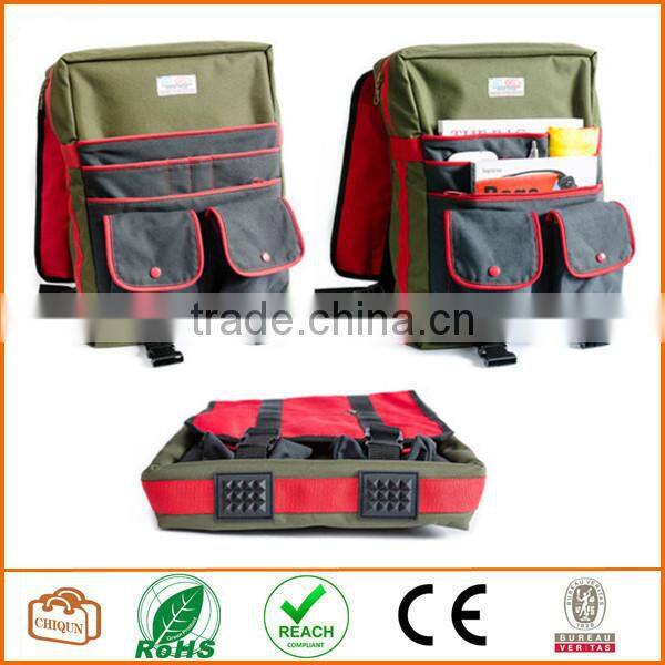 Red cotton twill and green nylon laminated water resistant fabric. Padded. Many pockets. Unique