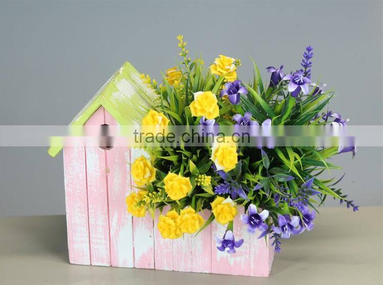 Small wooden house flower pot and garden planter